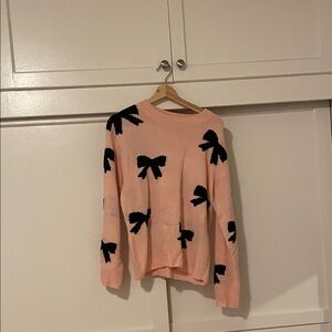 Pink Sweater with Black Bow Accents